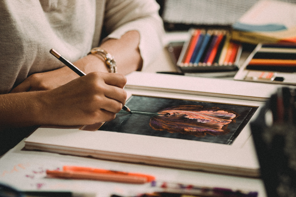 Creative woman drawing picture with pencil